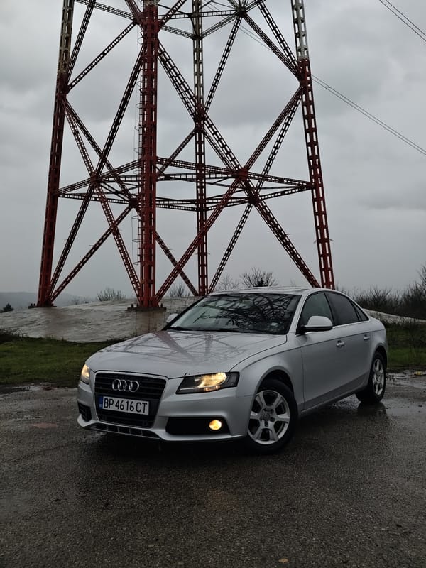 Silver Audi parked with lights on in overcast Kozloduy