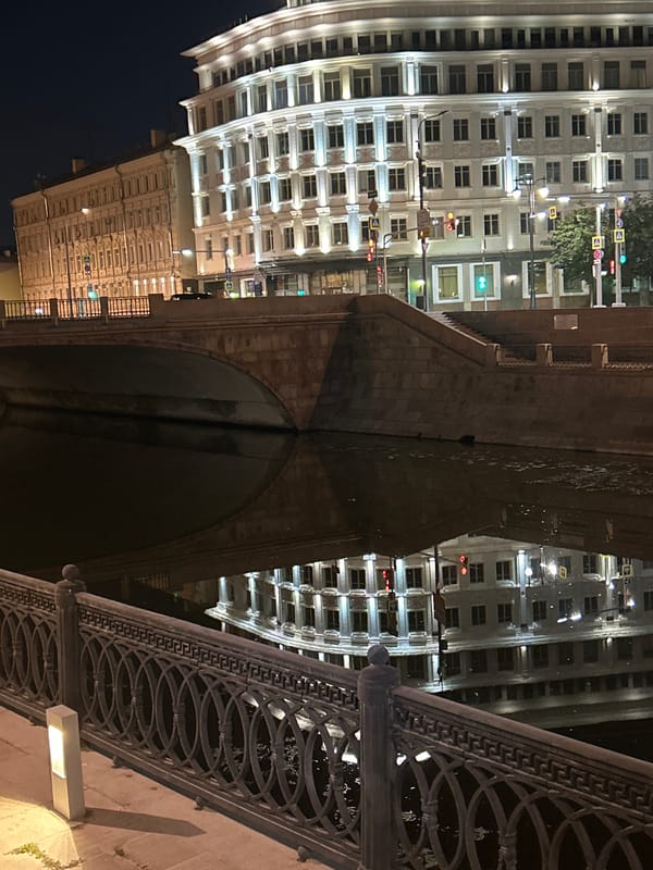 Ornate riverside building and surroundings at night