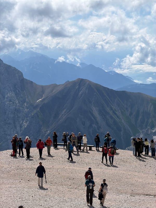 Tourists taking in layered alpine views at a Garmisch-Partenkirchen overlook