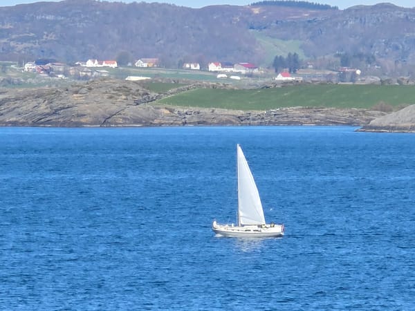 White-sailed boat spotted on Norwegian fjord waters near Randaberg