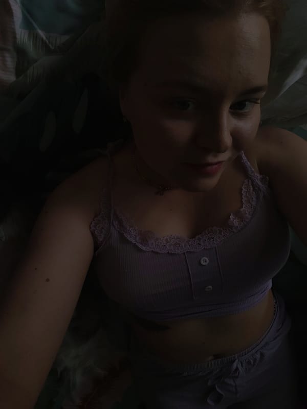 Woman relaxes in bed with dog in Izhevsk home