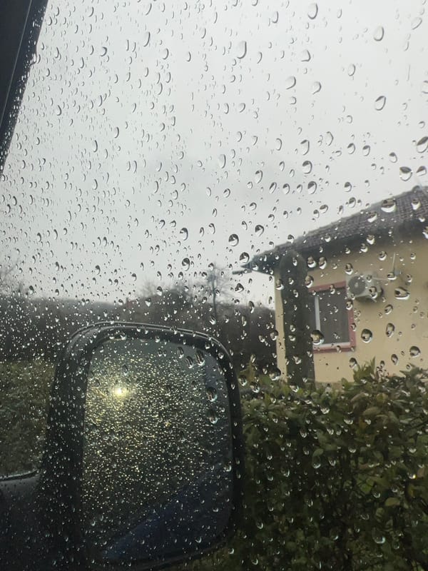 Rain-streaked windshield view captured during drive in Shumata, Bulgaria