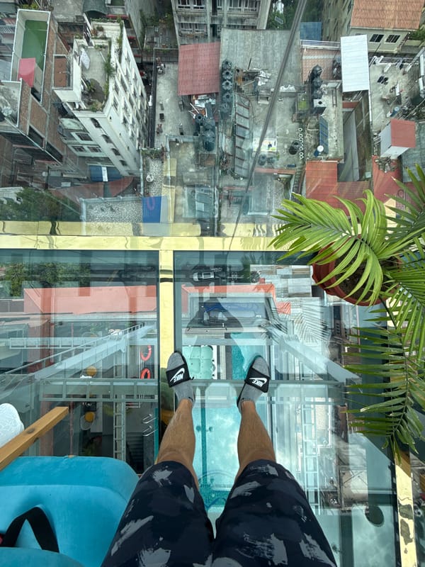 Glass-floor restaurant patron documents aerial Kathmandu cityscape views