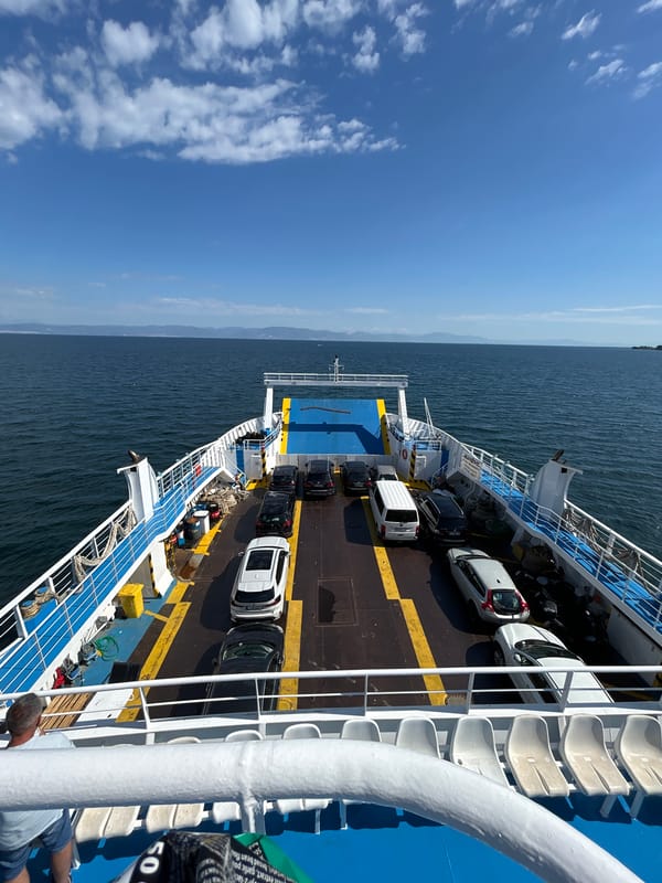 Cruising on a car ferry across open water on a clear day