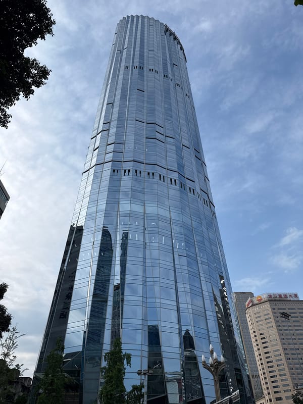 Modern tiered glass skyscraper observed in Jinjiang District, China