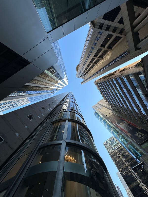 Looking up at Hong Kong's glass towers on a clear day
