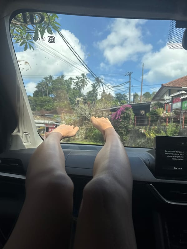 Person relaxes with feet up inside car in Bebandem