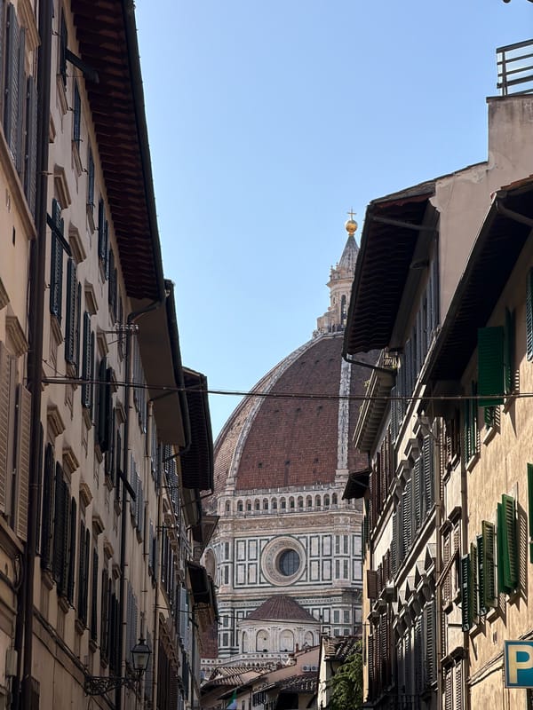 Street-level views captured of Florence Cathedral amid traditional architecture