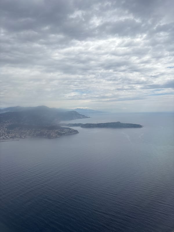 Foggy morning captures Nice coastline amid clouds and sea ripples
