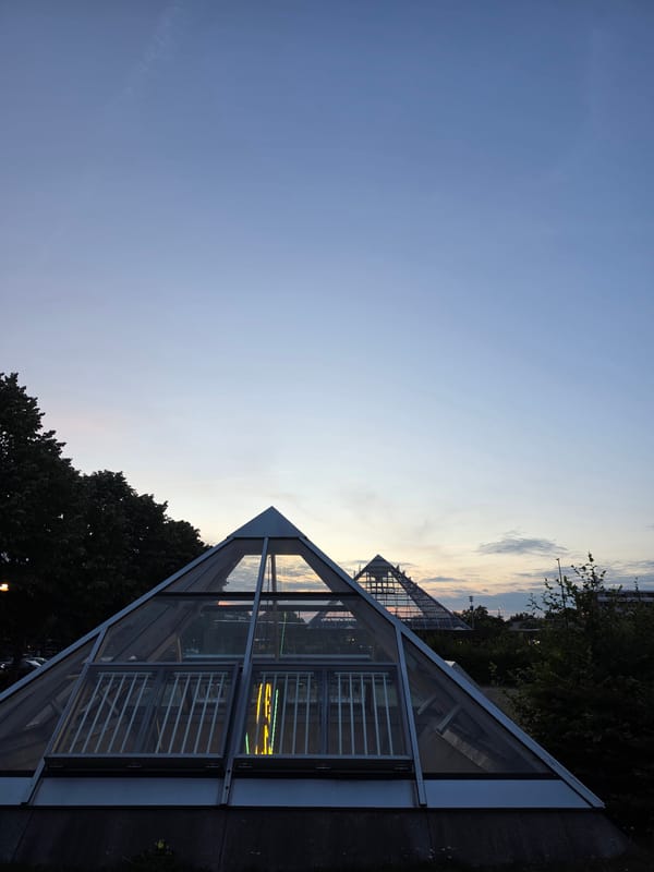 Glass pyramids and modern architecture glow at dusk in Rijswijk