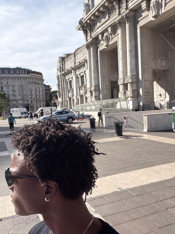 Moving through Milan — plaza, platform, and a train pulling in