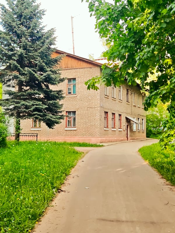 Brick building with red windows documented in Dmitrov, Russia