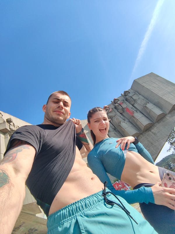 Couple poses at Bulgarian-Soviet Friendship Monument in Varna