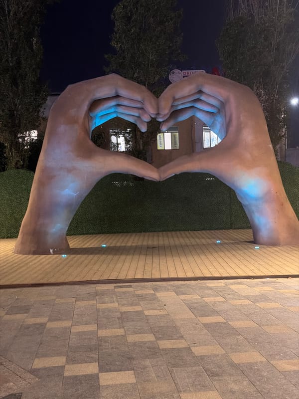 Tashkent park at night: fountains, sculptures, and lit-up rides