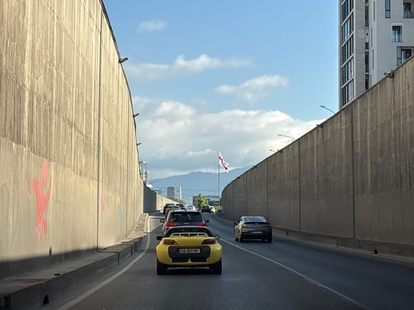 Morning traffic moves through a Tbilisi highway underpass
