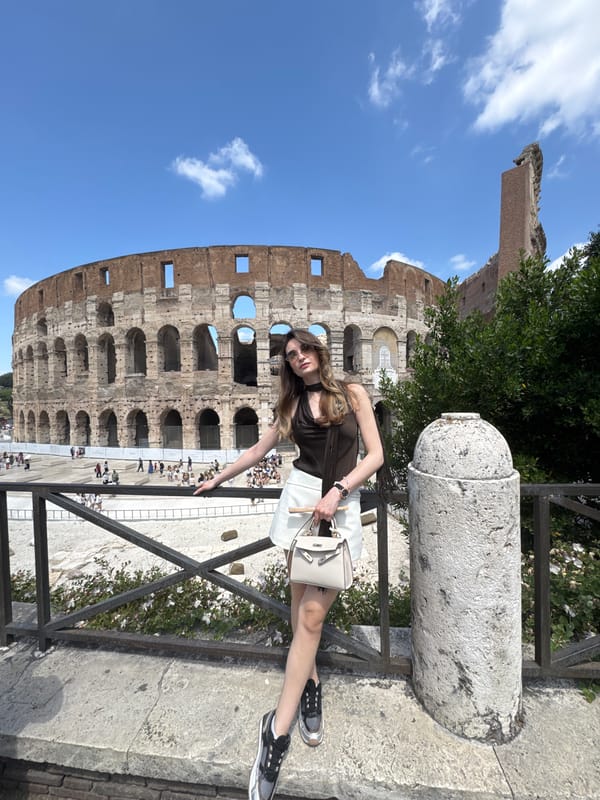 Tourist photographed at Rome's Colosseum during morning visit