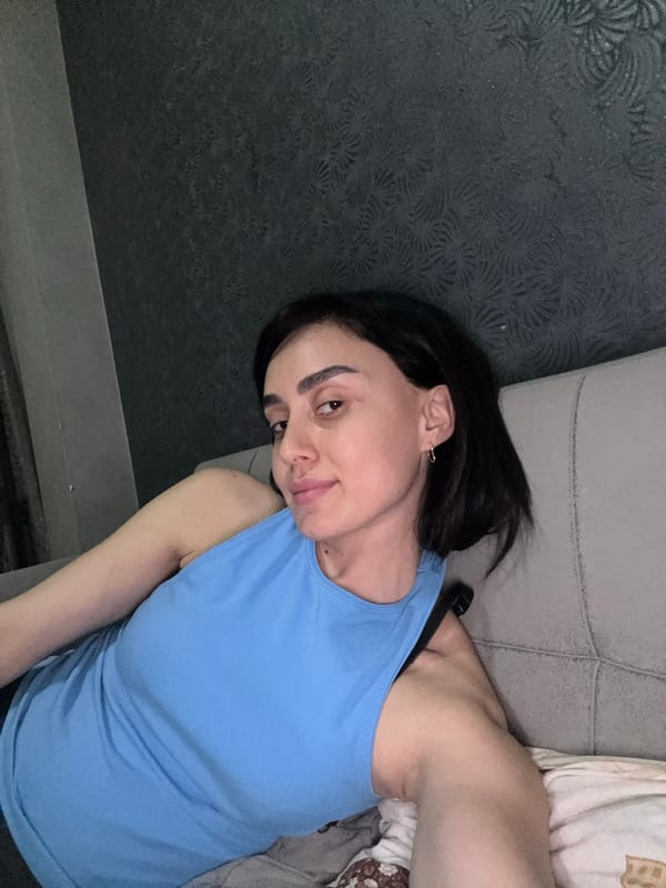 Woman rests on sofa in Tbilisi interior setting