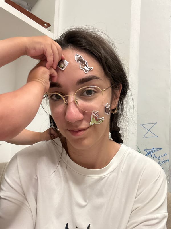 Woman with stickers on face photographed in children's room