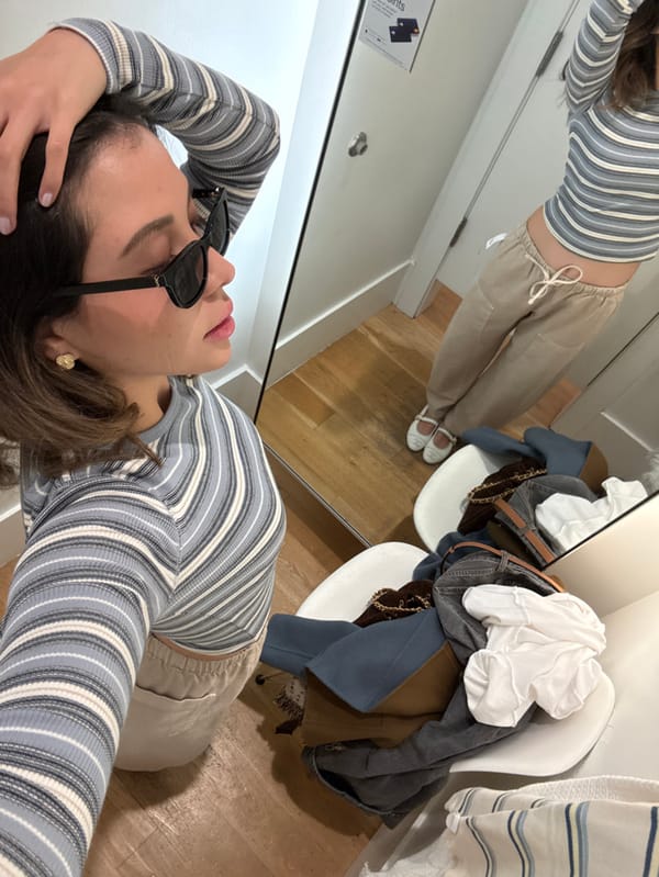 Woman tries on multiple outfits in Miami Beach fitting room