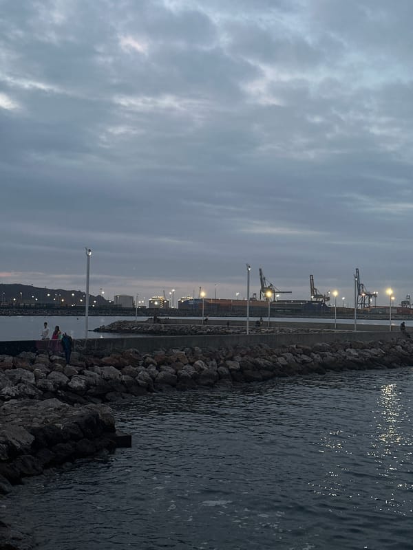 Evening scenes captured at Gijón port and beach under overcast skies