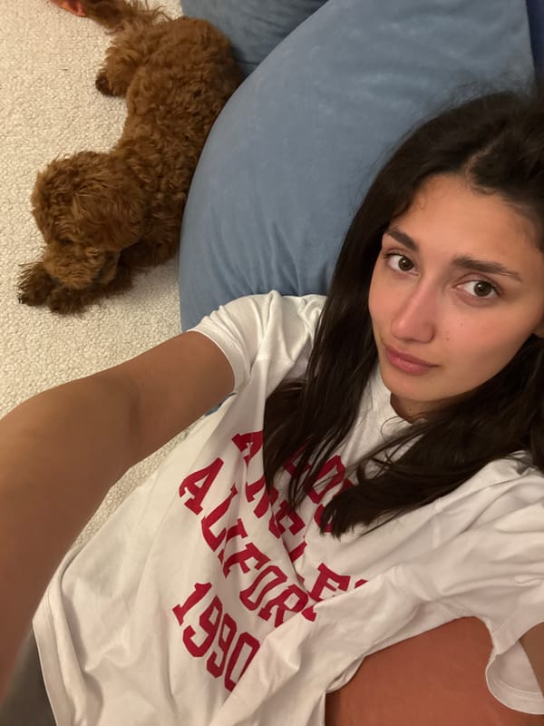 Woman rests with poodle in Sutomore, Montenegro