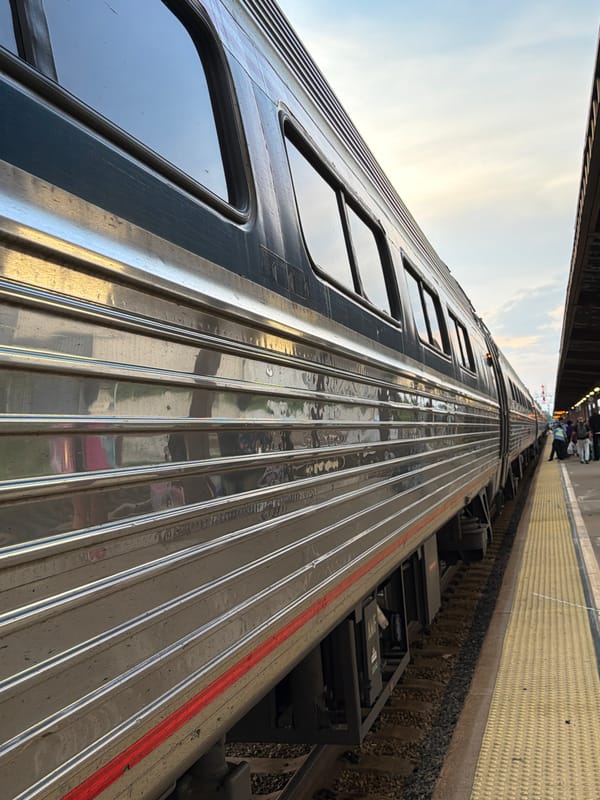 Silver commuter train at a Dumbarton station