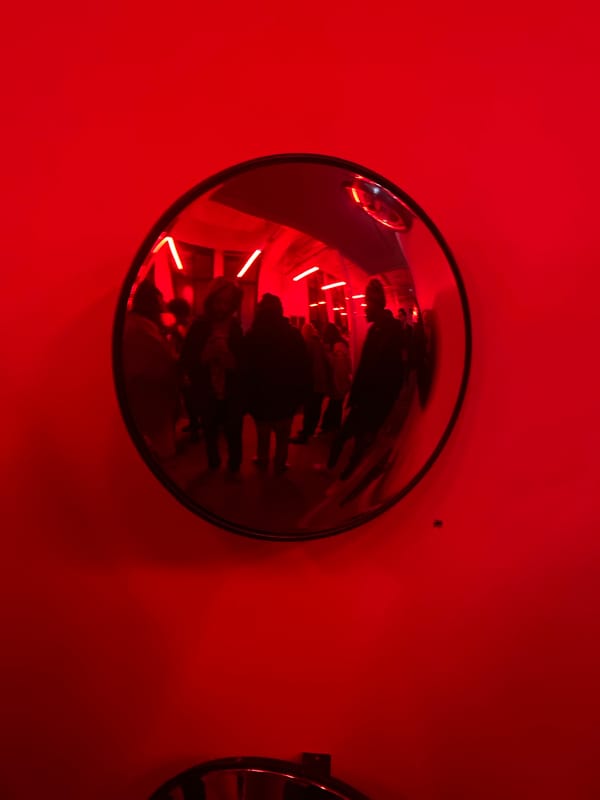 Red-lit architectural space documented in Paris with Eiffel Tower views