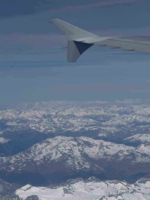 Aerial view of snow-covered mountains captured over northern Italy