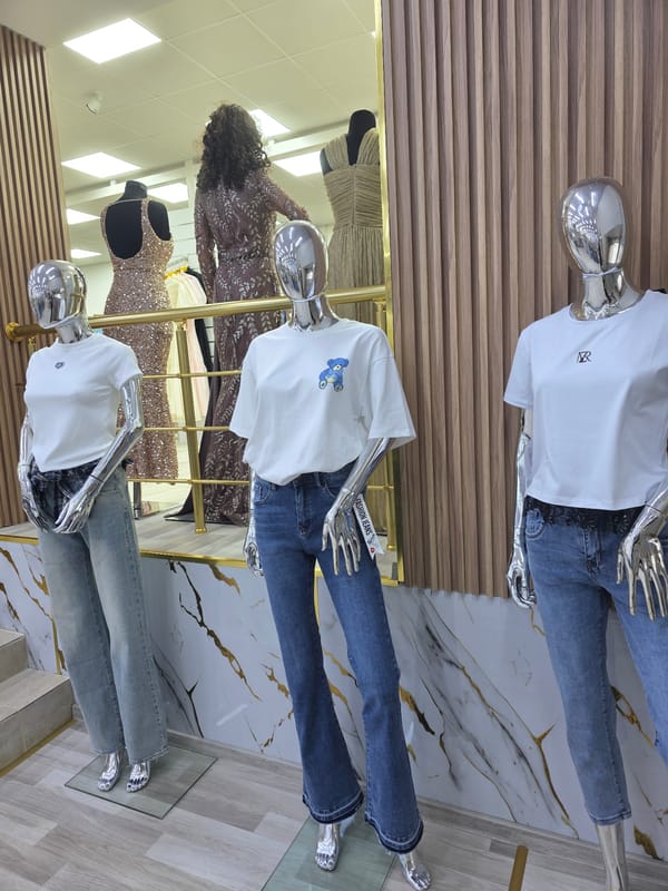 Clothing store display features mannequins in casual wear