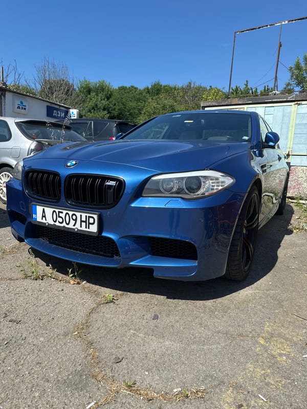 Blue BMW M5 photographed from multiple angles in outdoor lot