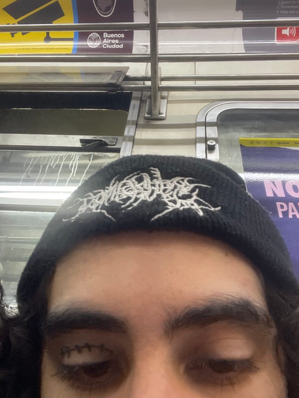 Tattooed individual photographed at Buenos Aires subway station