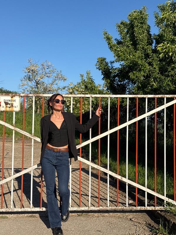 Woman poses on striped gate in Pleven, Bulgaria