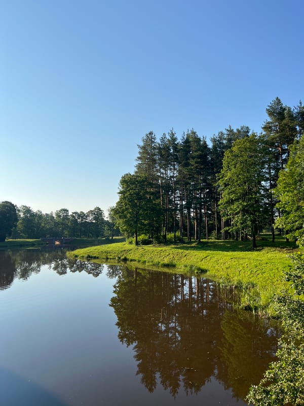 Still lake and brick-lined waterfall in Pushkin's summer parks