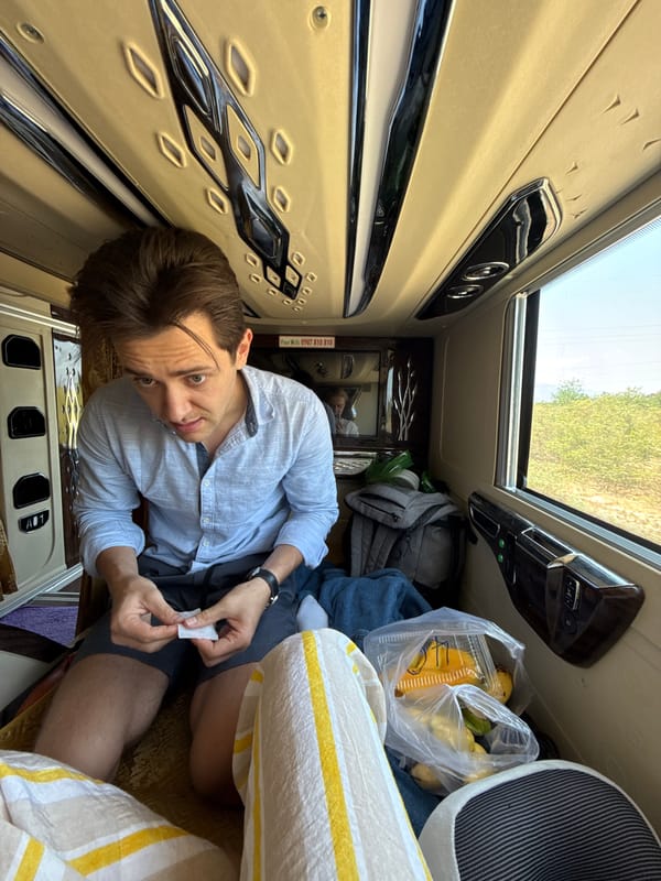 Passenger rests in sleeper bus cabin in Vietnam