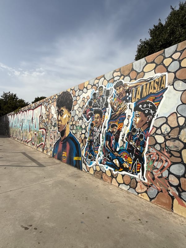 Soccer-themed graffiti mural on a mosaic wall in Mataró