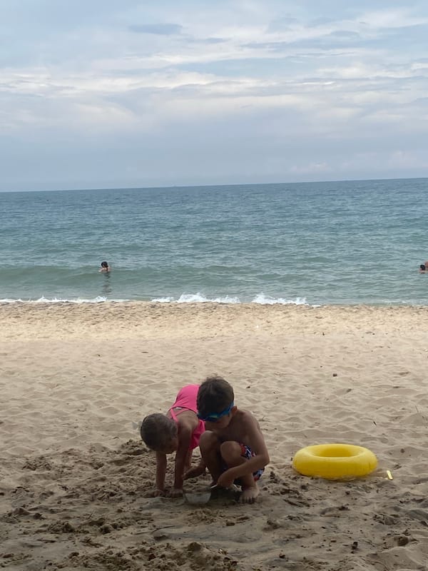Beach day at a Vietnamese resort, kids playing, adults relaxing