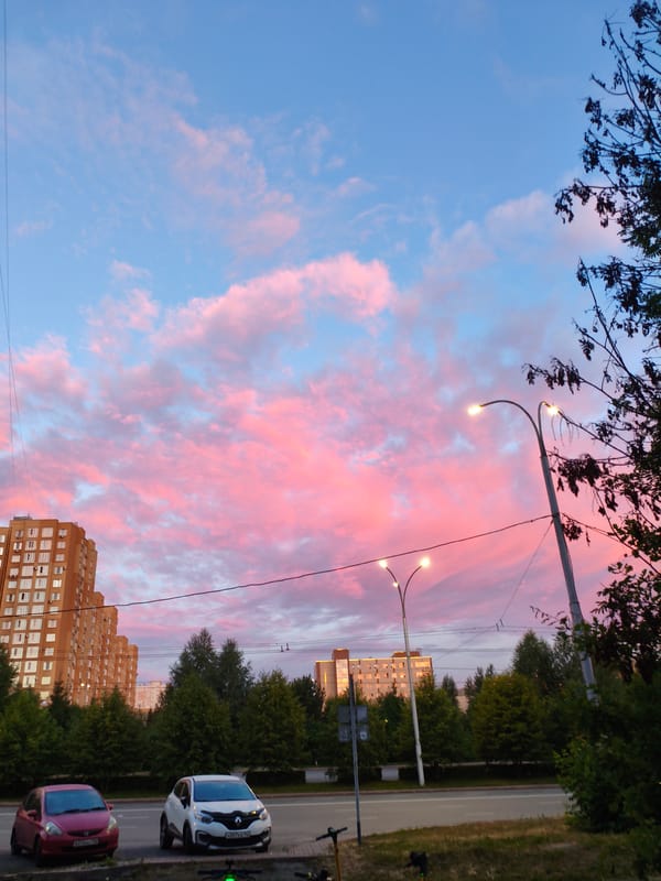 Kemerovo street at sunset, pink clouds over evening traffic