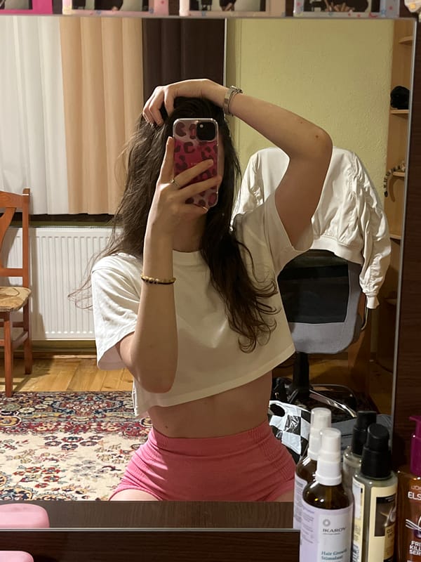 Woman takes selfies indoors in Popintsi, Bulgaria