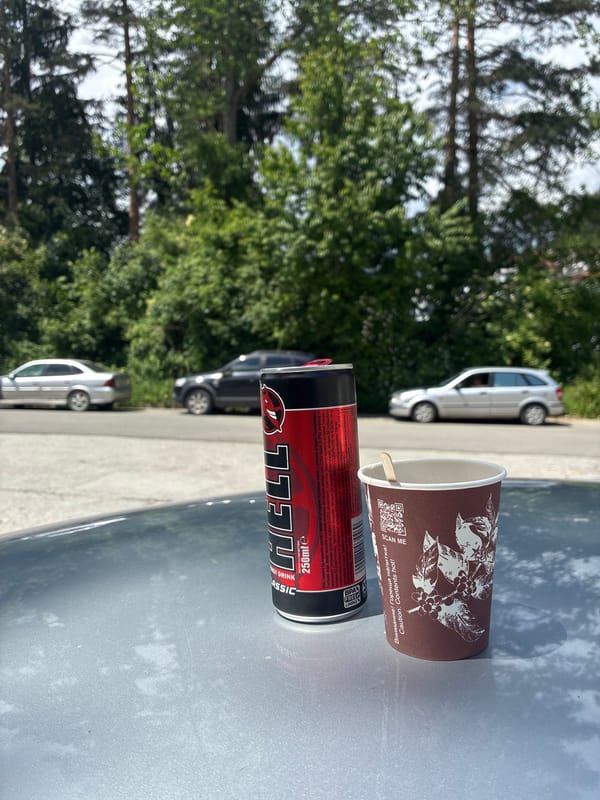 Energy drink and cup spotted on car hood in Smolyan