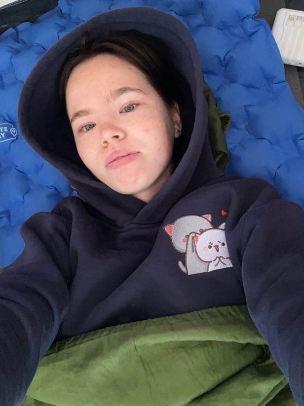 Crashed out on an inflatable mat in a green sleeping bag