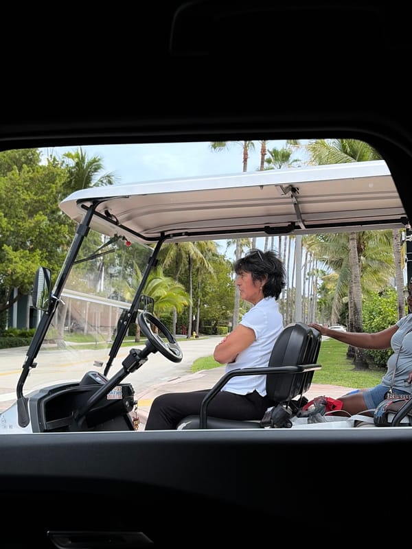 Woman sits in golf cart in Key Biscayne
