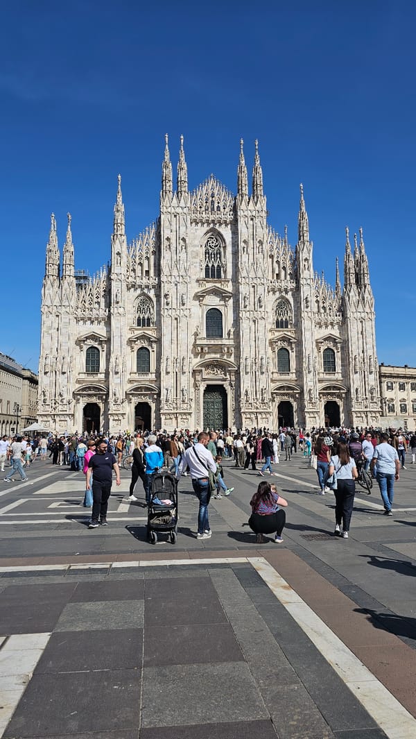 Tourists gather at Milan Cathedral and Galleria on sunny afternoon