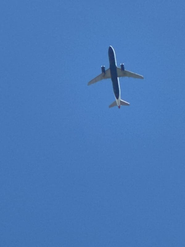 Commercial jets tracked across a clear south London sky