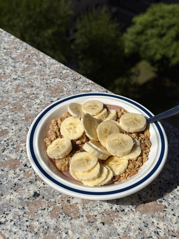 Breakfast bowl photographed on outdoor granite surface in Milan