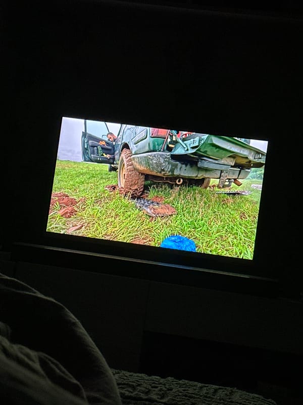 TV shows utility vehicle stuck in muddy field
