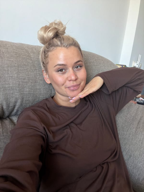 Woman photographs herself relaxing on sofa in Sarapul, Russia