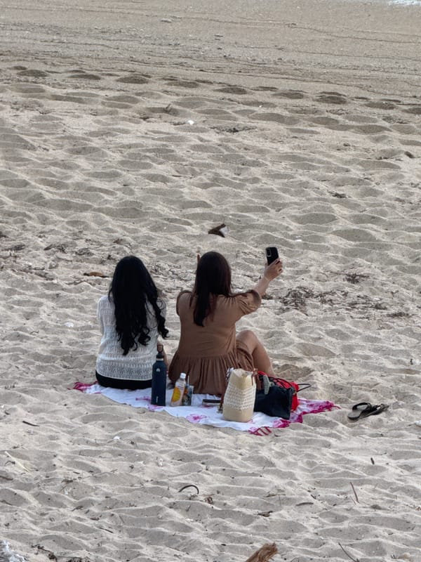 Beach day in Kuta Selatan: sand, surf, and a paraglider
