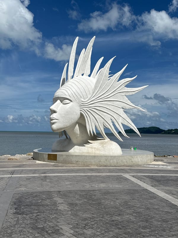 Phuket landmarks: sculptures, tourist signs, and a shipwreck
