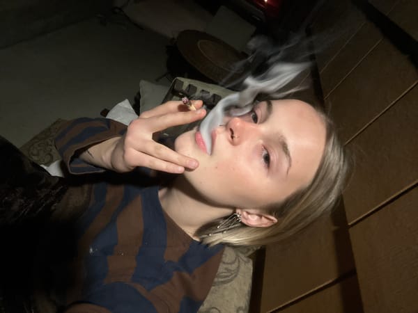 Woman smoking cigarette indoors in Whistler early morning