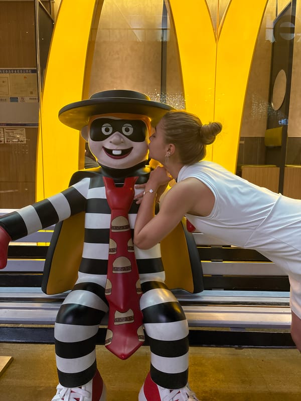 Woman poses with McDonald's displays in Panyu District